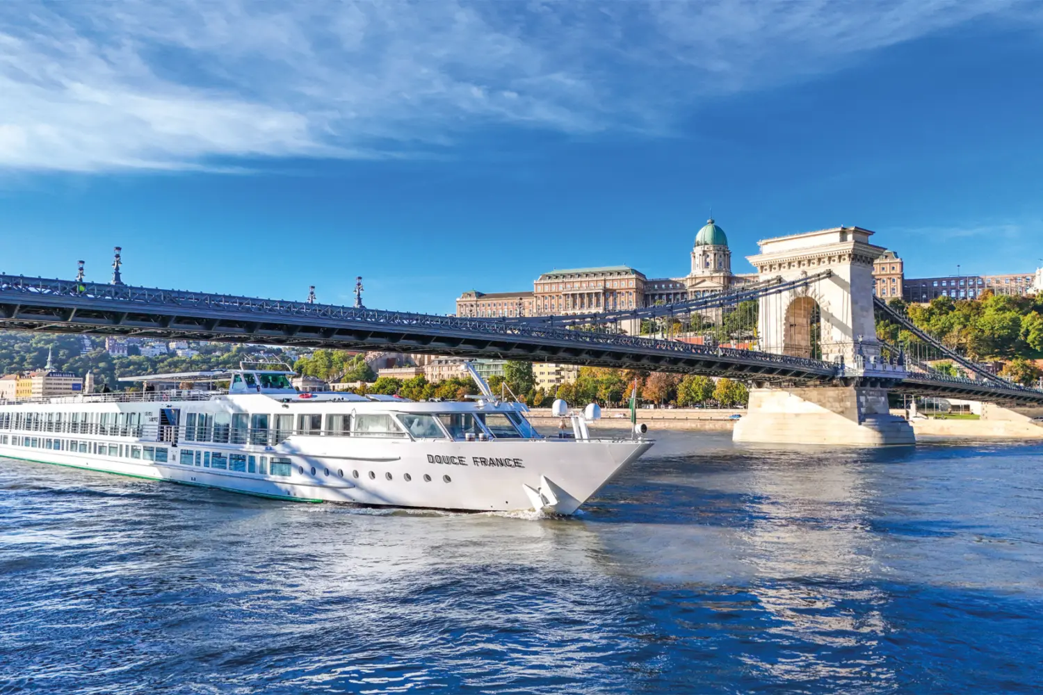 Vue extérieure sur le MS Douce France de CroisiEurope naviguant sur le Danube avec en arrière-plan la ville de Budapest en Hongrie