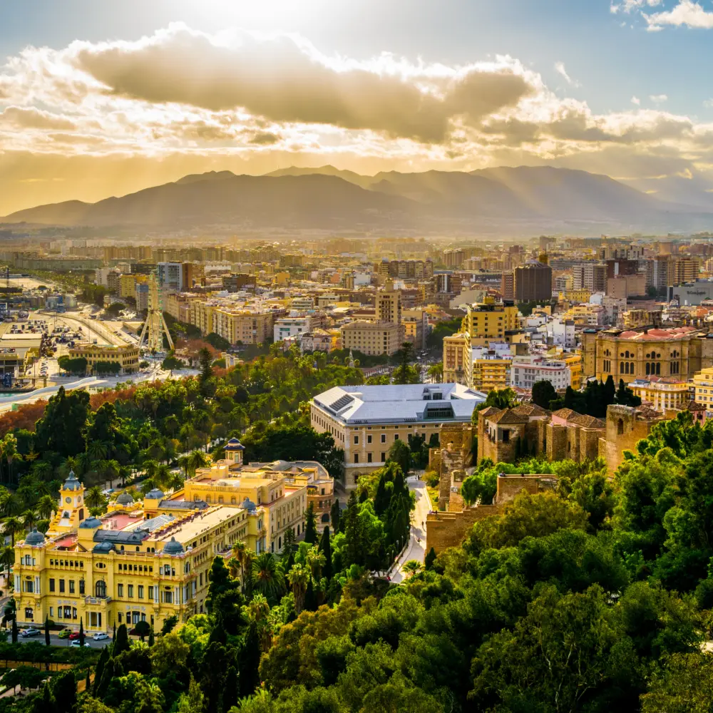 Vue aérienne de Malaga prise depuis le château de gibralfaro comprenant le port de Malaga, le château d'Alcazaba et la cathédrale de Malaga pendant le coucher du soleil