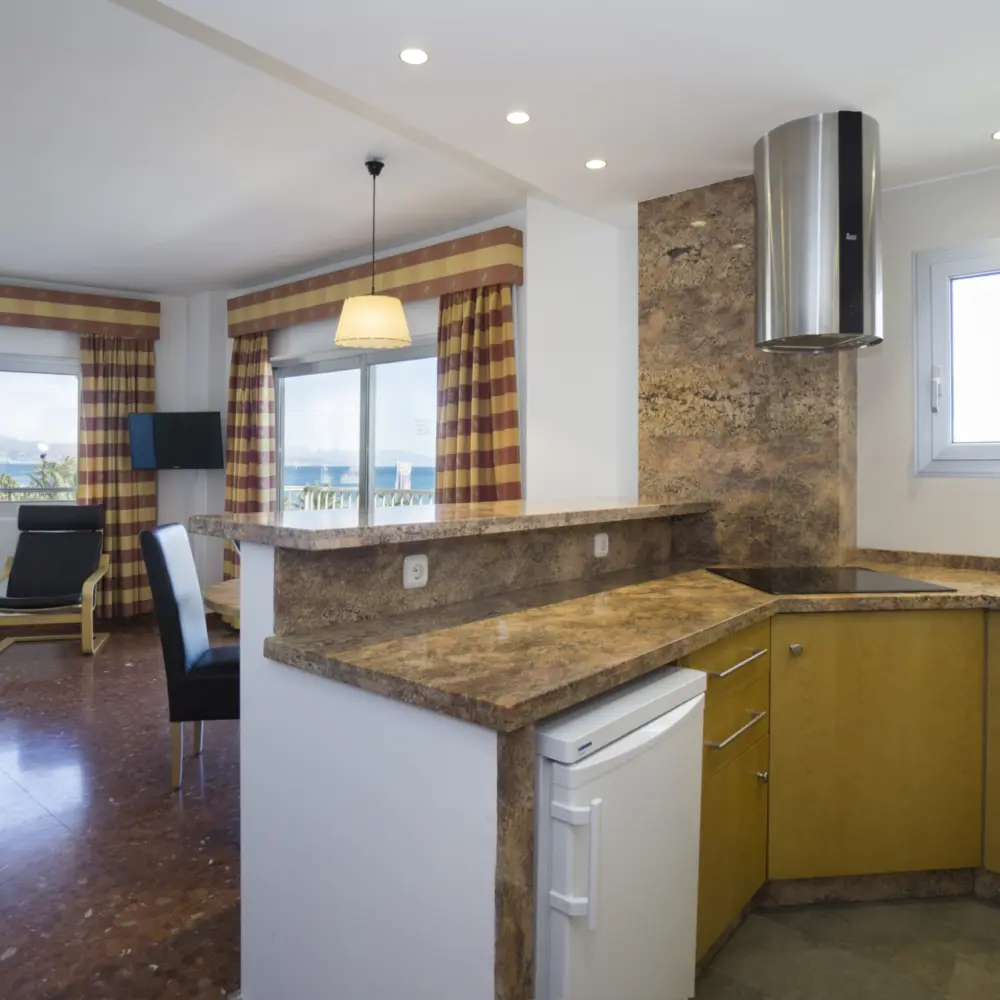 Salon et cuisine offrant une vue sur la mer Méditerranée à l'hôtel Bajondillo à Torremolinos en Espagne